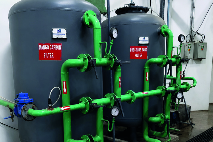 Pressure sand and activated carbon vessels with connected process pipework.